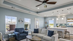 A spacious living room with a sofa, armchairs, and a coffee table. - Beach Access~Barefoot Bliss~Chef Kitchen~Family (Bolivar Peninsula)