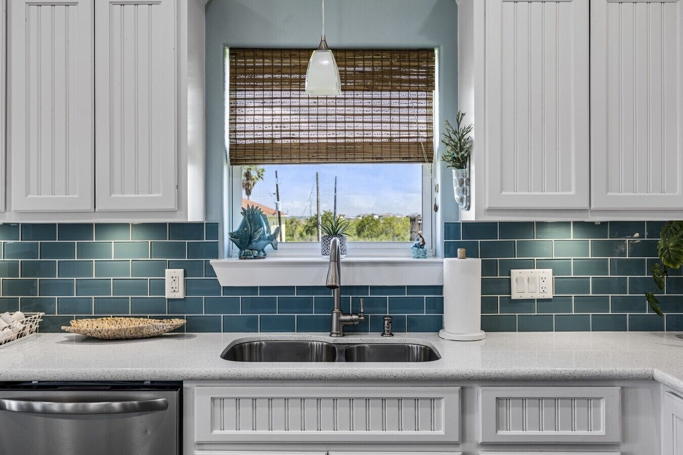 A kitchen with a window, a sink, and a countertop.