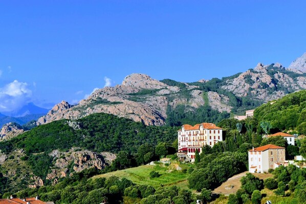 A mountainous landscape with buildings on a hillside.