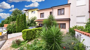 A residential area with houses, a car, and various plants. - Apartment 2439/240919 (Istria - Stinjan), 1000m from the beach (Stinjan)
