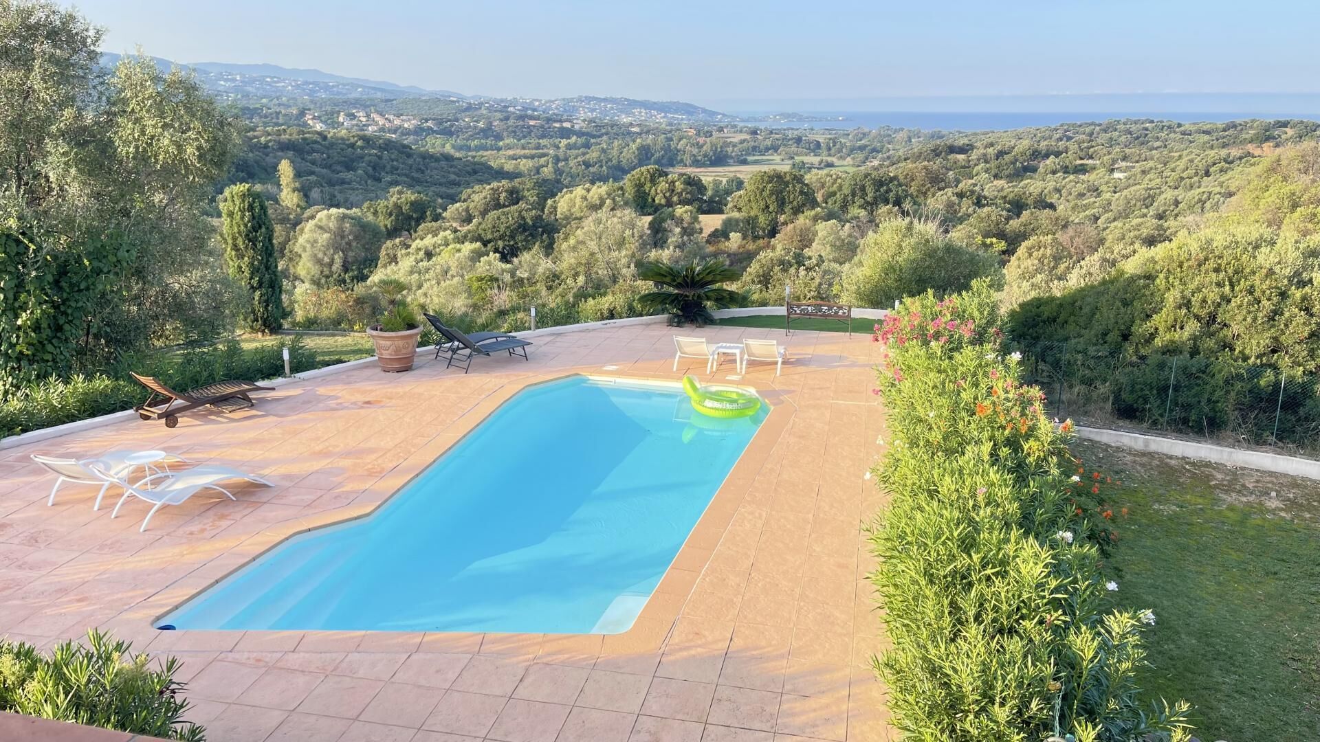 A swimming pool with a view of a hilly landscape.