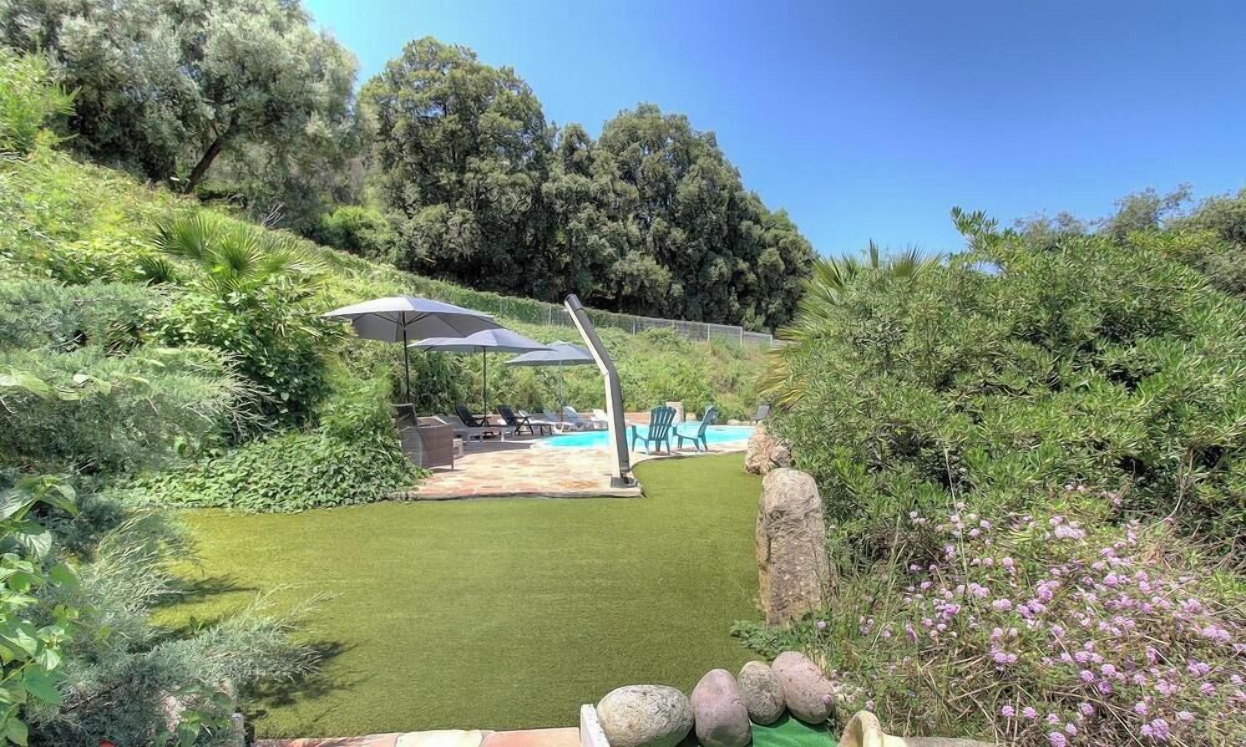 A backyard with a pool, outdoor furniture, and a pergola.