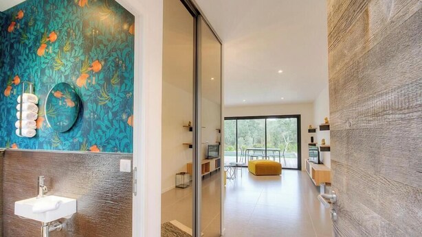 Un intérieur moderne comprenant une salle de bain, un coin repas et un espace de vie.