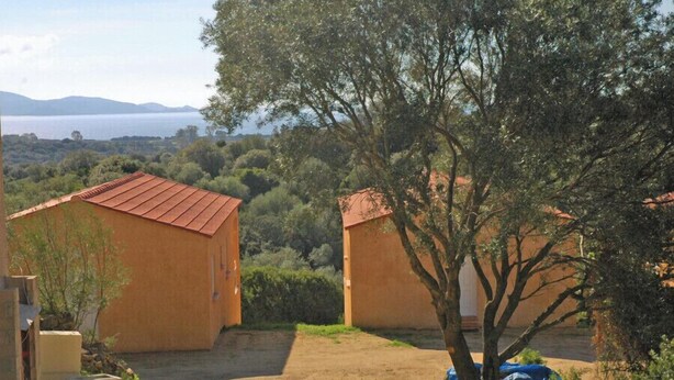 Two rustic buildings with red roofs, surrounded by greenery and a view of a body of water. - The 2nd - SERRA DI FERRO (SERRA DI FERRO)