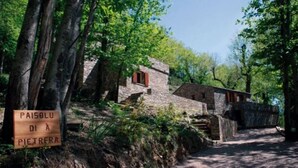 A rustic stone building with a sign reading 'PAISOLU DI A PIETRERA'. - Petrera 1 - CASABIANCA (CASABIANCA)