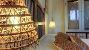 A wicker lamp, a bed with pillows, and a window with blinds. - Résidence U Quarciu - GHISONACCIA (GHISONACCIA)