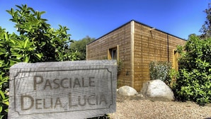 A wooden building with a sign reading 'Pascale Delia Lucia.' - Pasciale delia Lucia (SAINTE LUCIE DE PORTO VECCHIO)