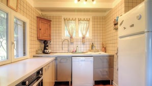 A compact kitchen with a dishwasher, a coffee maker, and a refrigerator. - In Castiniccia - CASAGLIONE (CASAGLIONE)