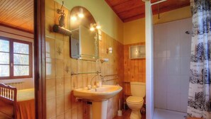 Une salle de bain avec un lavabo, un miroir et des toilettes.