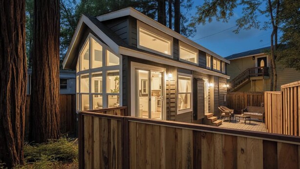 A modern house with large windows, a deck, and a staircase leading to an upper level. - NEW! The Gilded Grove Cottage in Charming Guerneville (Guerneville)