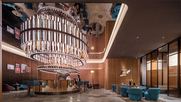 A modern lobby with a central circular light fixture, seating areas, and a reception desk. - Crystal Hotel Weihai Happiness Gate (Weihai)