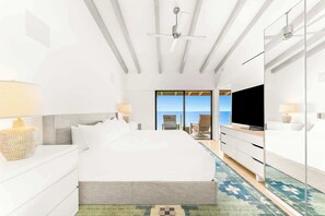 A modern hotel room with a large bed, a TV, a seating area with a view, and a balcony. - Oceanfront Solana Beach 2 BDR Condo (Solana Beach)
