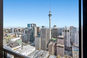 A cityscape with a prominent tower, modern buildings, and a clear sky. - Cute with a View & Carparking too (Auckland CBD)
