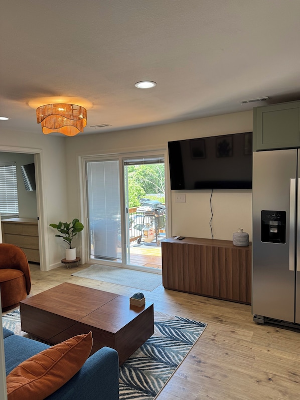 A modern living room with a sofa, coffee table, and a television.