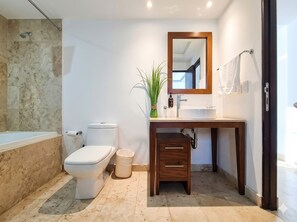 A bathroom with a toilet, sink, mirror, and a plant. - ICON Oceanview Retreat by Monyxbnb (Puerto Vallarta)