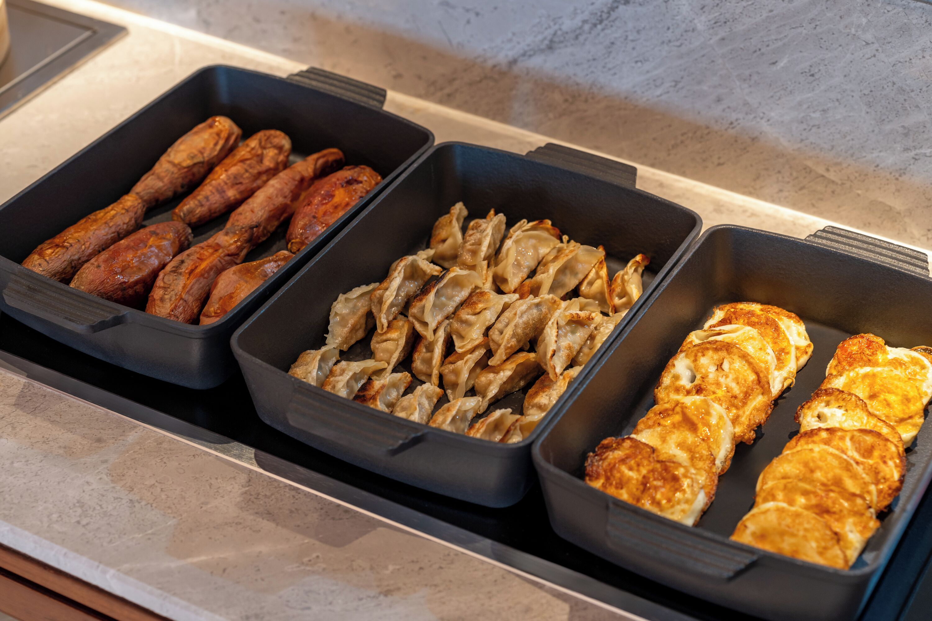 Three food trays with different dishes.