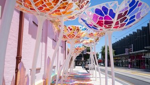 A street lined with colorful, patterned umbrellas.