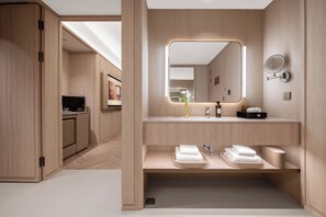 A modern bathroom with a wooden vanity, a large mirror, and a towel rack. - Crystal Hotel Yantai Municipal Gov MixC (Yantai)