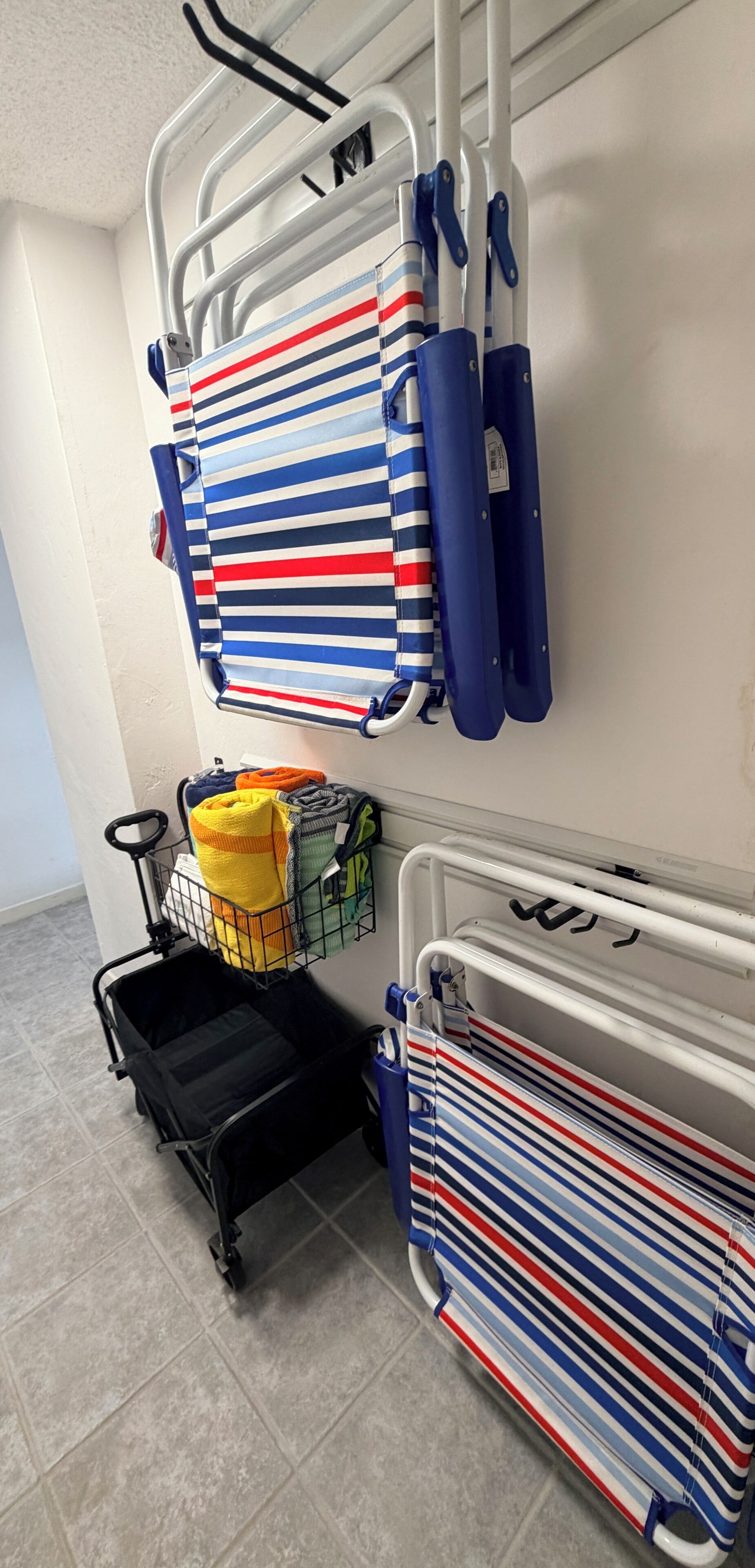 A storage area with striped fabric items and a shopping cart.