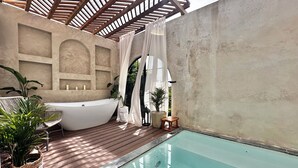 A spa area with a hot tub, a small pool, wooden decking, potted plants, and a pergola. - The Sanctuary Private Pool & outdoor spa (Rincón)