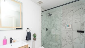 A bathroom with a white sink, mirror, and toilet. - Central 1BR in Miami Near Wynwood and Marlins Park (Miami)