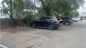 A parking lot with multiple cars parked along the side of a road. - Fabulous condo with AC in the heart of Clifton, 8 mins to Giant’s Stadium (Clifton)