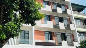 A multi-story hotel with balconies, a flat facade, and a sign indicating it is the TLT - KHÂNH AN3 HOTEL. - Dong Thanh Hotel (Vo Cuong)