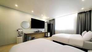 A hotel room with two beds, a desk, a TV, a mirror, and a shower area. - Ayana Hotel & Resort (Mokpo)