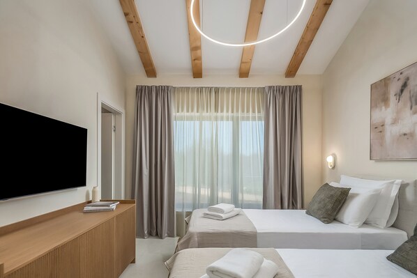 A hotel room with a bed, a TV, a bedside table, and a window with curtains. - Nareo Villa Collection - Villa Nara, Labin, Croatia (Labin)