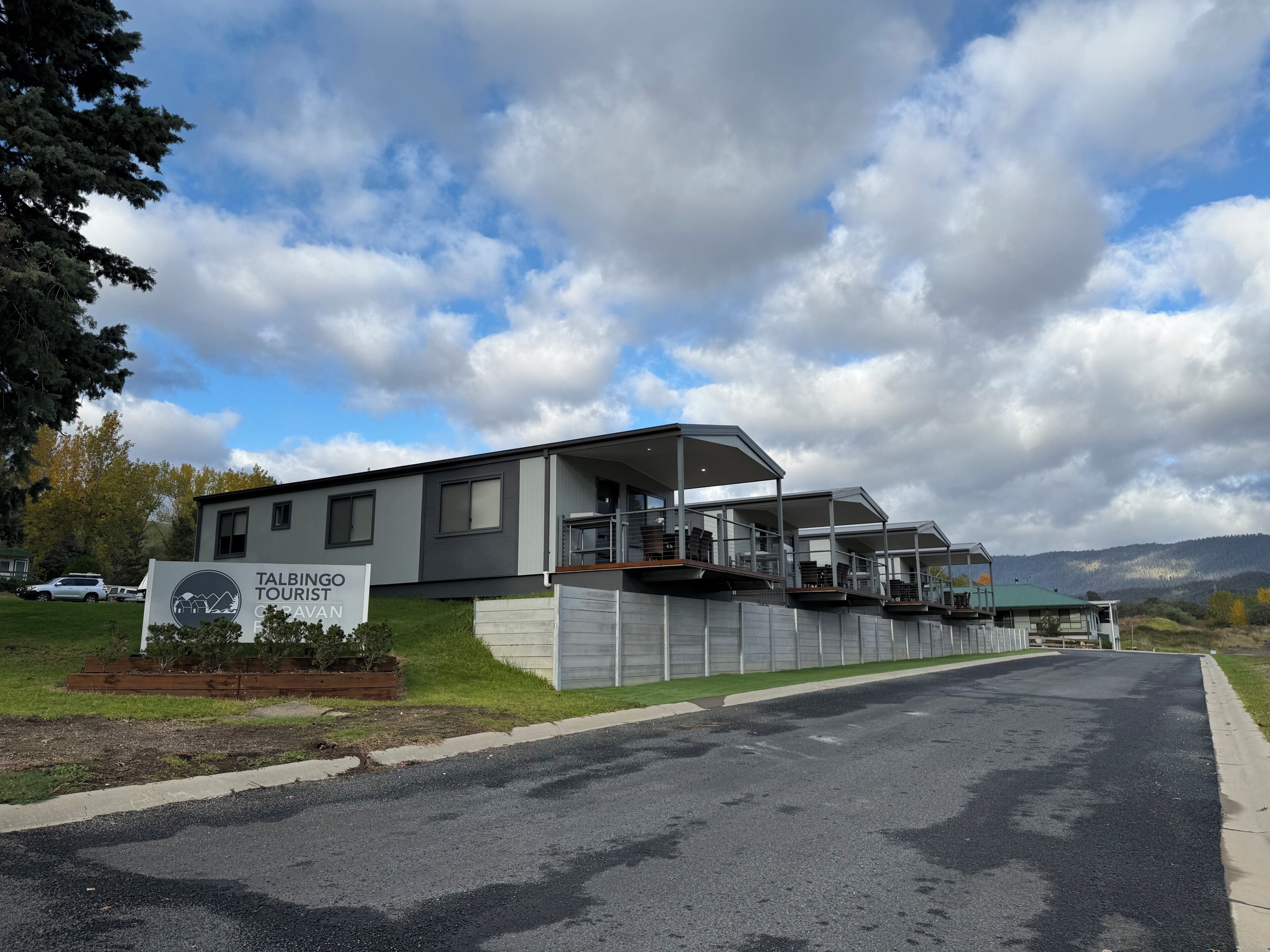A modern building with a sign for Talbingo Tourism Gravan.