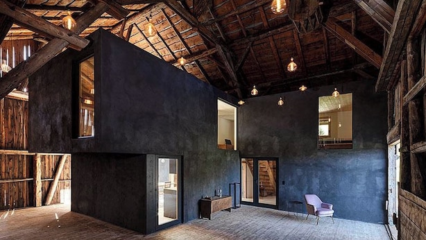 A spacious interior with exposed wooden beams, large windows, and a modern design. - Alphütte Briula Appartement/Fewo, Dusche, WC, 3 Schlafräume by Interhome (Valbella)