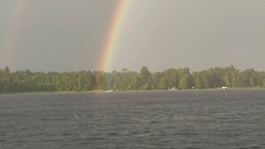A body of water with a rainbow and a forested shoreline. - The Narrows on Lawrence Lake
Privacy, Hot Tub, Beach, Dock, Quick Trail Access (Outing)