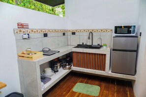 A compact kitchen with a microwave, refrigerator, and a small sink. - Tree House La Fortuna w/Jacuzzi (La Fortuna)