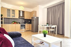 A compact living space with a kitchenette, a dining area, and a sofa. - Holiday Apartment With Sea View - 180, Sarandë, Albania (Sarandë)