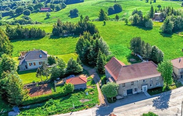 An aerial view of a rural area with houses surrounded by green fields and trees. - 2 bedroom beautiful apartment in Lachamp Raphael (Lachamp Raphael)