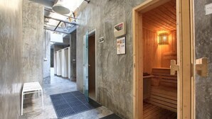 A sauna room with wooden benches, a small white table, and a mat on the floor. - 2 Bedroom Unique Indoor Pool Villa (Bophut)