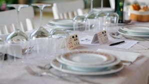 A table set for a meal with numbered place cards, a bottle, and a basket of bread. - Hotel Club i Pini- Residenza d'Epoca (Camaiore)