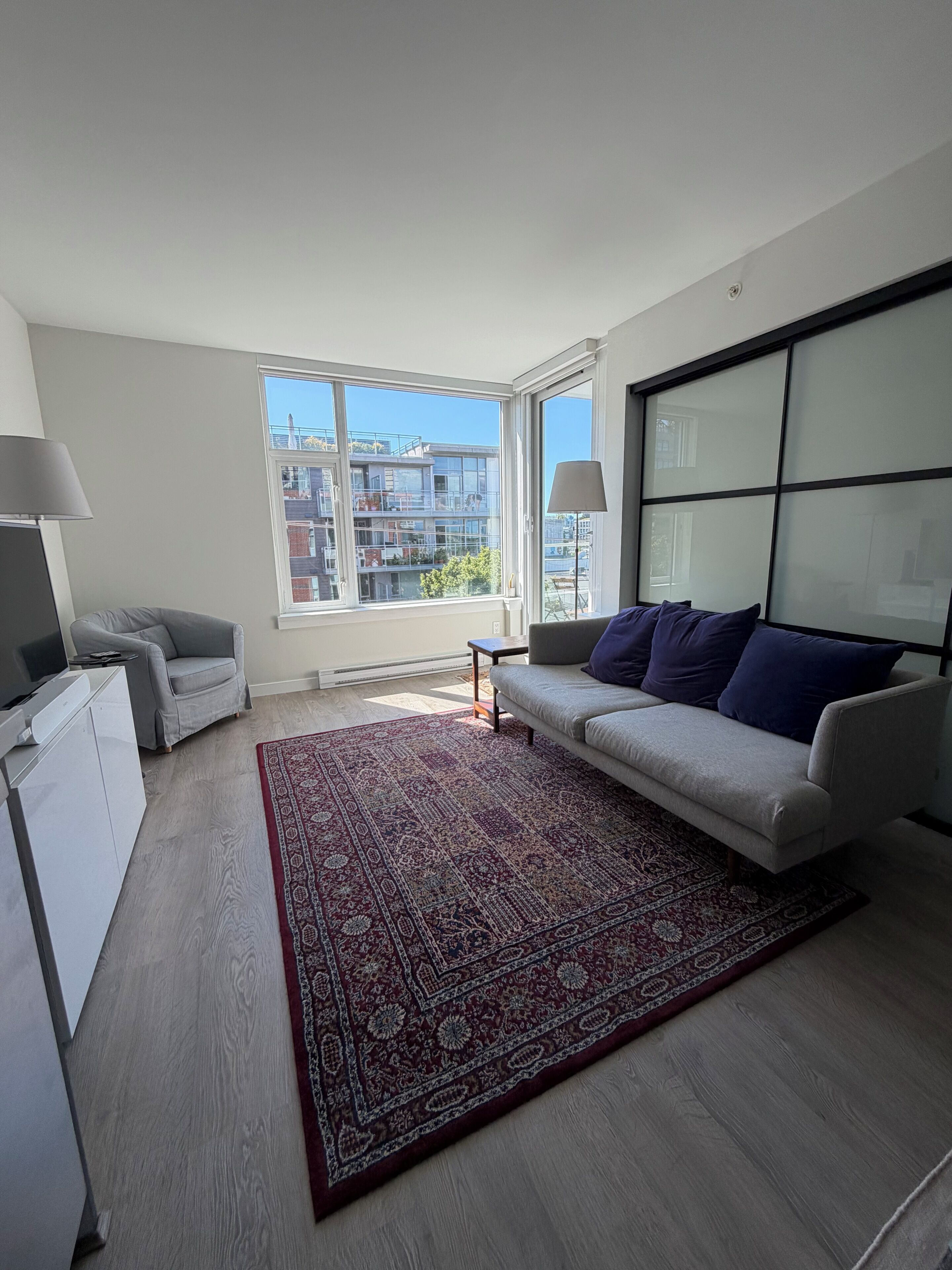 Living area. Bright 1BR + DEN in Mt Pleasant · 9 min to BC Place