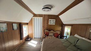 A room with a bed, a window, a ceiling fan, and wooden walls. - Durango Oasis: Trout Ponds, Wildlife & Trails (Durango)
