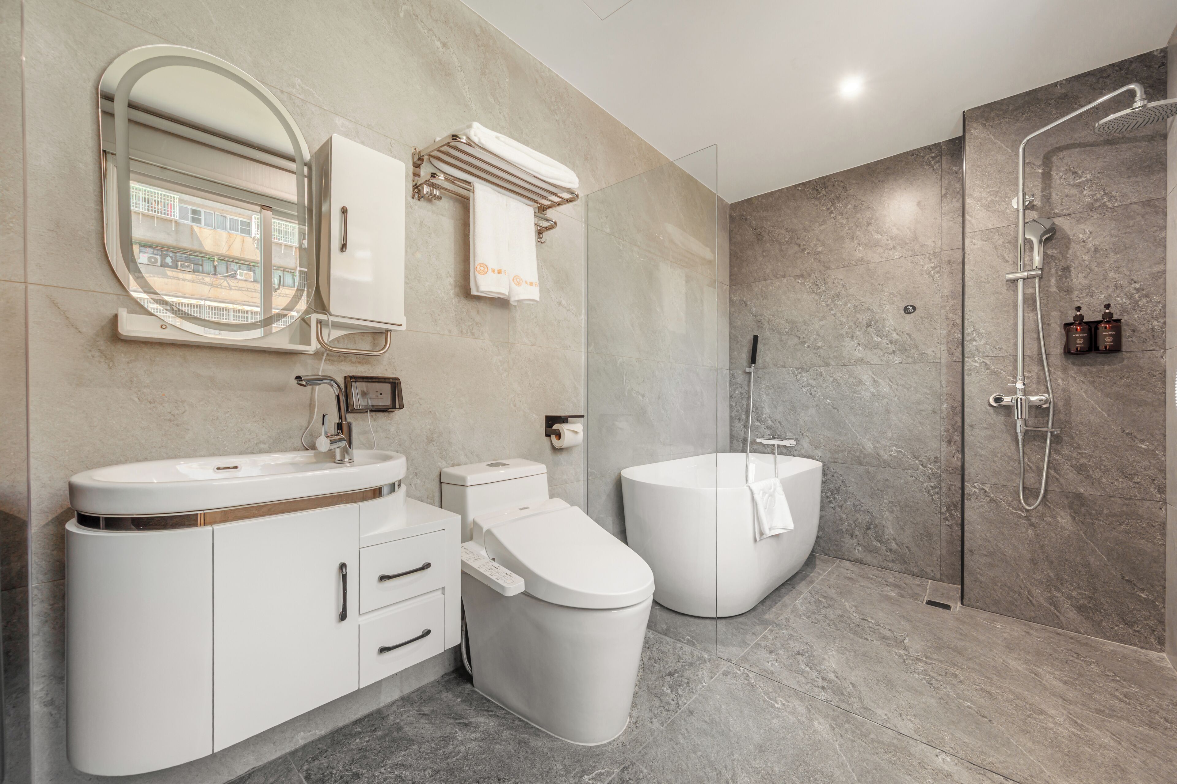 A modern bathroom with a toilet, bidet, and shower.