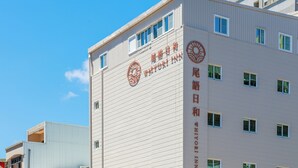 A building with a sign that reads 'WHYORI INN' and features multiple windows and a clear sky in the background. - WHIYORI INN (Kaohsiung)