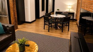 A compact living space with a dining area, a sofa, and a coffee table. - Brick & Bed - Arch, Riverfront, Convention Center, T-303 (St. Louis)
