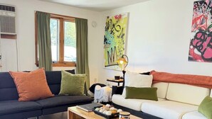 A modern living room with a sofa, a coffee table, and a rug. - 2nd floor flat in the Midtown Arts District (Kingston)