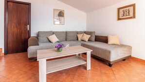 A living room with a sofa, a coffee table, and a door. - Kristalis by Interhome (Medulin)