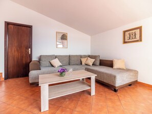 A living room with a sofa, a coffee table, and a door. - Kristalis by Interhome (Medulin)