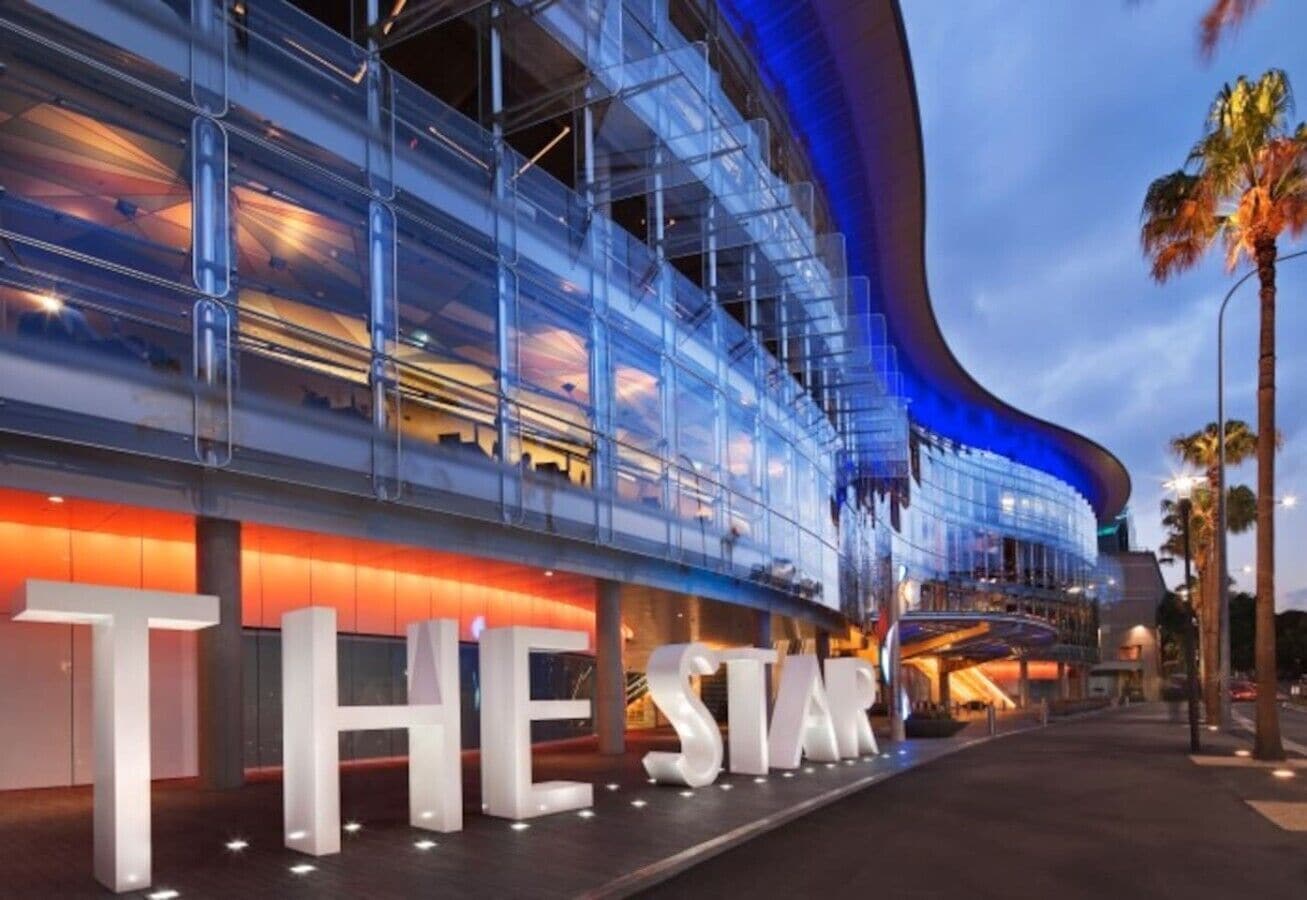 A modern building with large illuminated letters spelling 'THE STAR' on the ground.