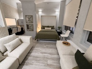 A modern bedroom with a bed, two sofas, a desk, and a window. - Classic City Unit with Parking and walk to Harbour (Pyrmont)
