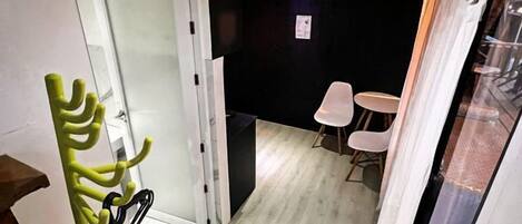 A staircase leading to a room with a white door, a small table, and a chair.