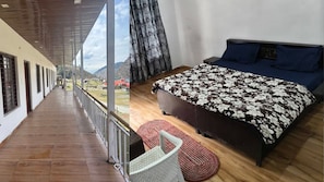 A bedroom with a bed, a window, and a view of a mountainous landscape. - Swastik Hotel and Restaurant (Banglo Ki Kandi)