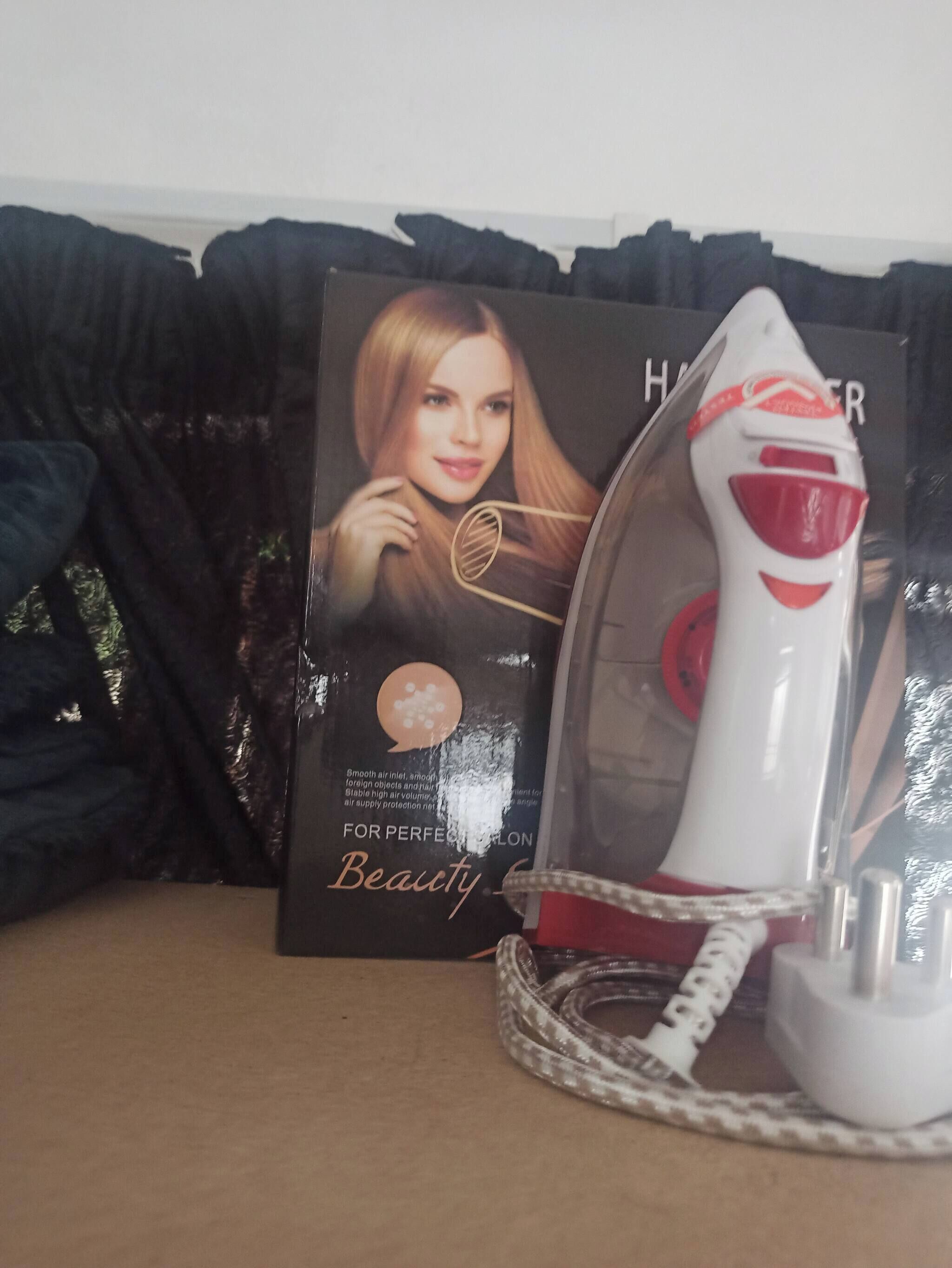 A hairdryer and its packaging on a table.